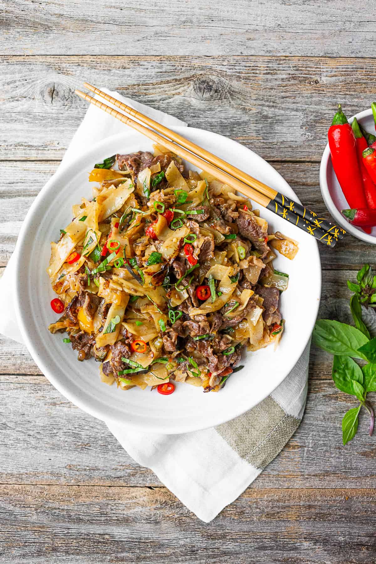 Thai Beef Drunken Noodles in a large white bowl.