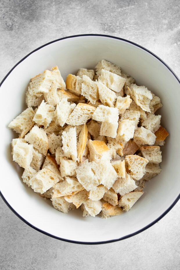 Cut up sourdough bread in a bowl. 