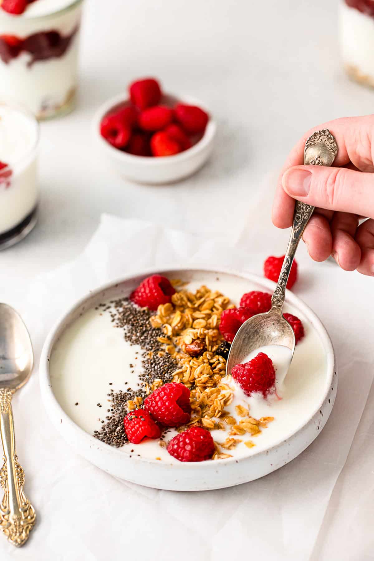 A hand spooning out a bite of Instant Pot Yogurt. 