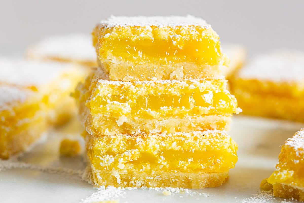 Homemade Lemon Bars stacked on top of each other. 