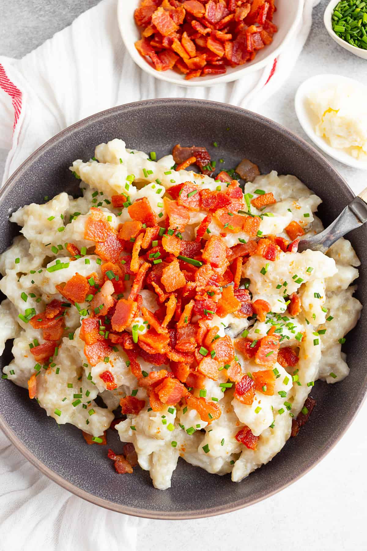 Potato Halusky (Bryndzové halušky) topped with crispy bacon. 
