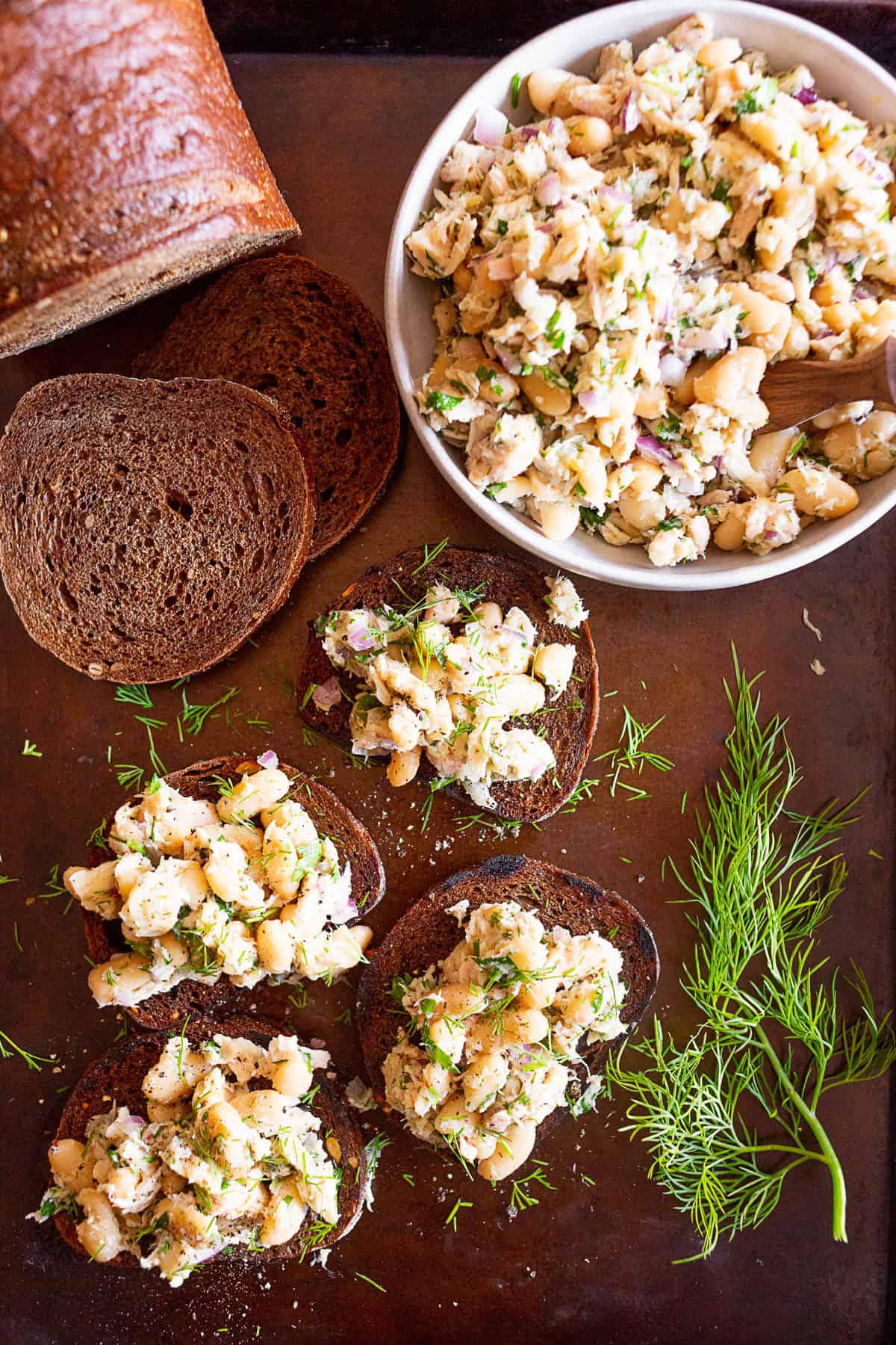 Tuna White Bean Herb Salad served on dark bread.