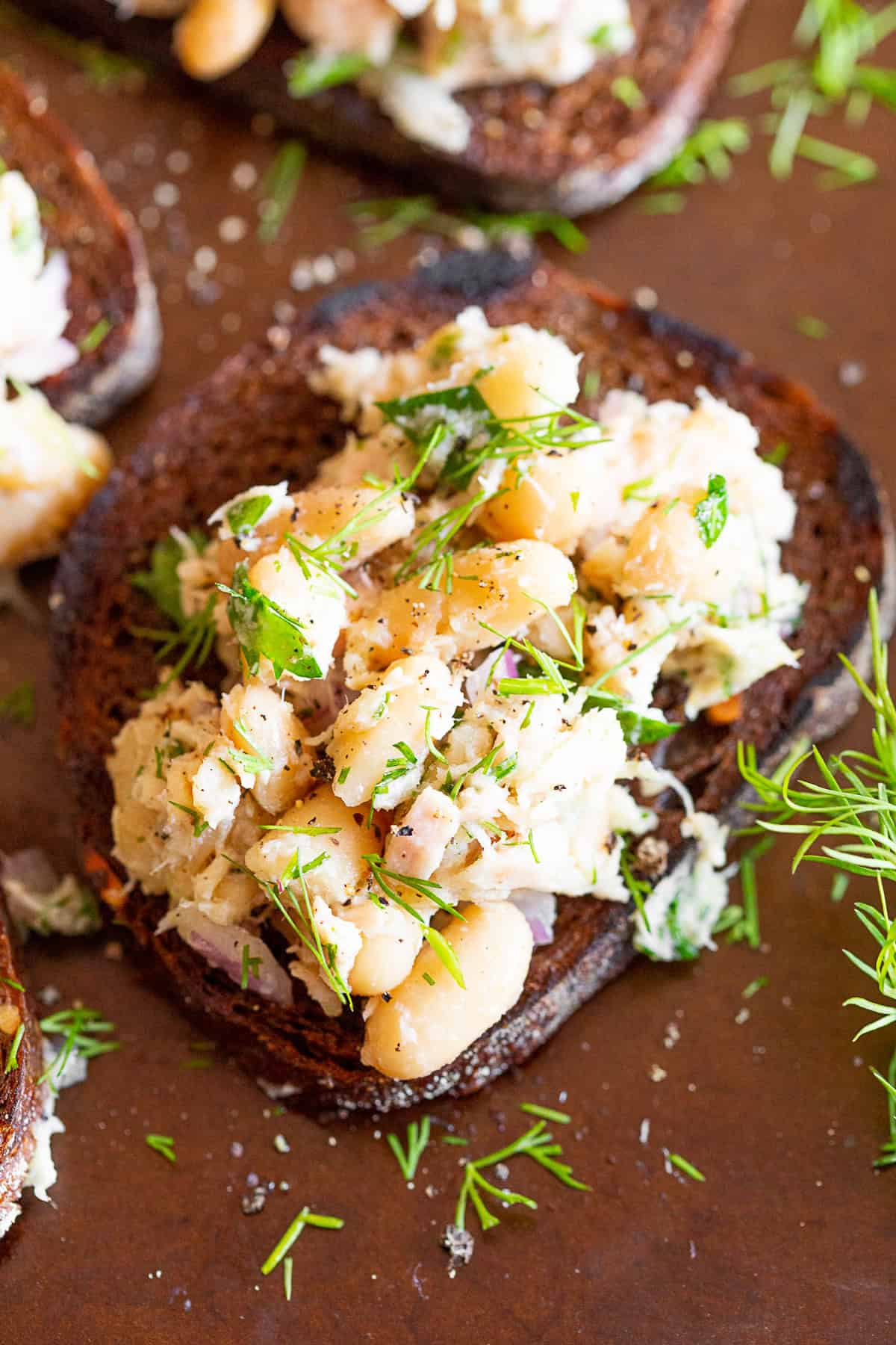 Tuna White Bean Herb Salad served with a sprinkle of fresh herbs.