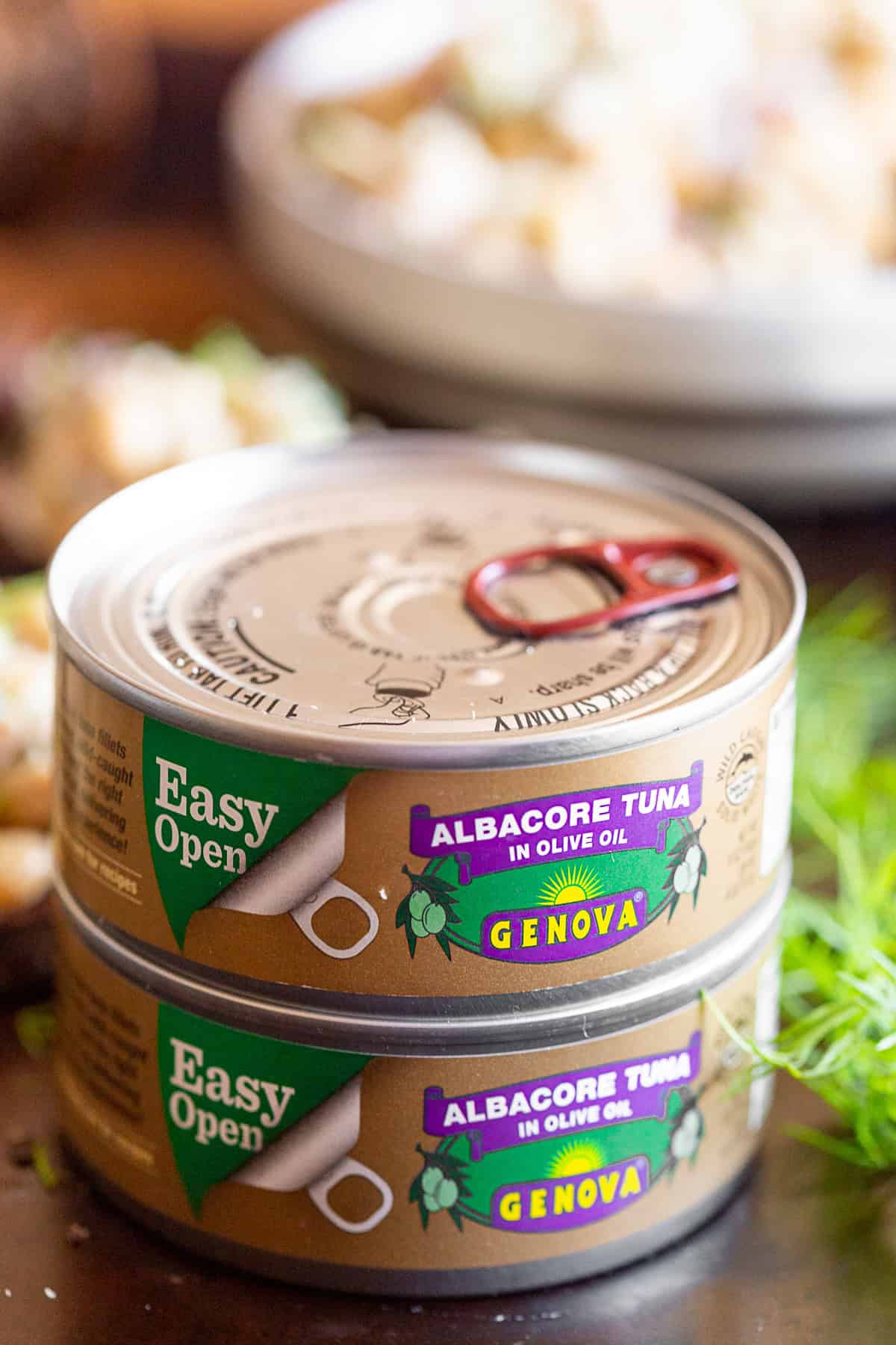 cans of tuna stacked on top of each other.