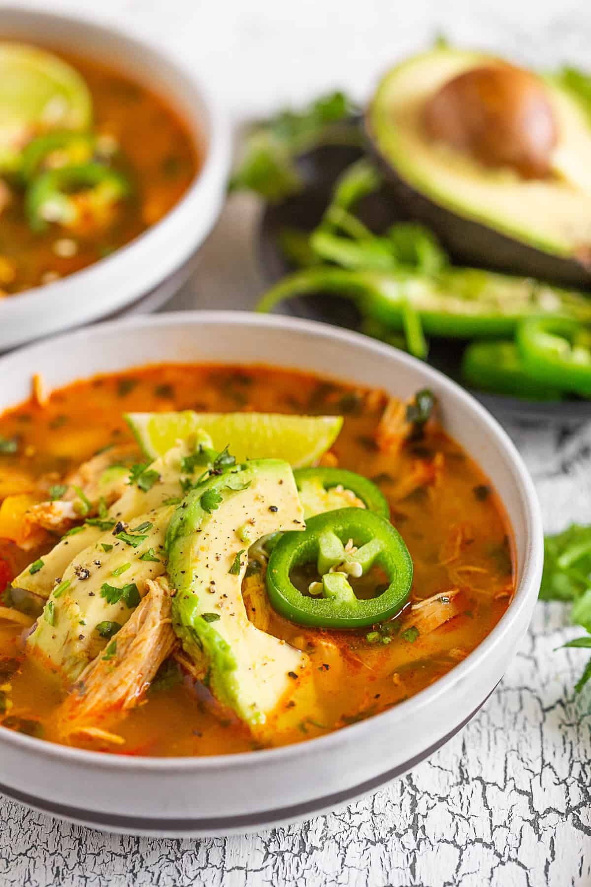 Chicken Avocado Cilantro Lime Soup topped with avocado and cilantro.