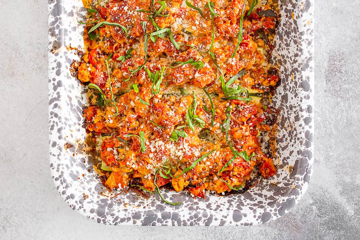 Ground Chicken Parmesan Stuffed Zucchini Boats in a baking dish.