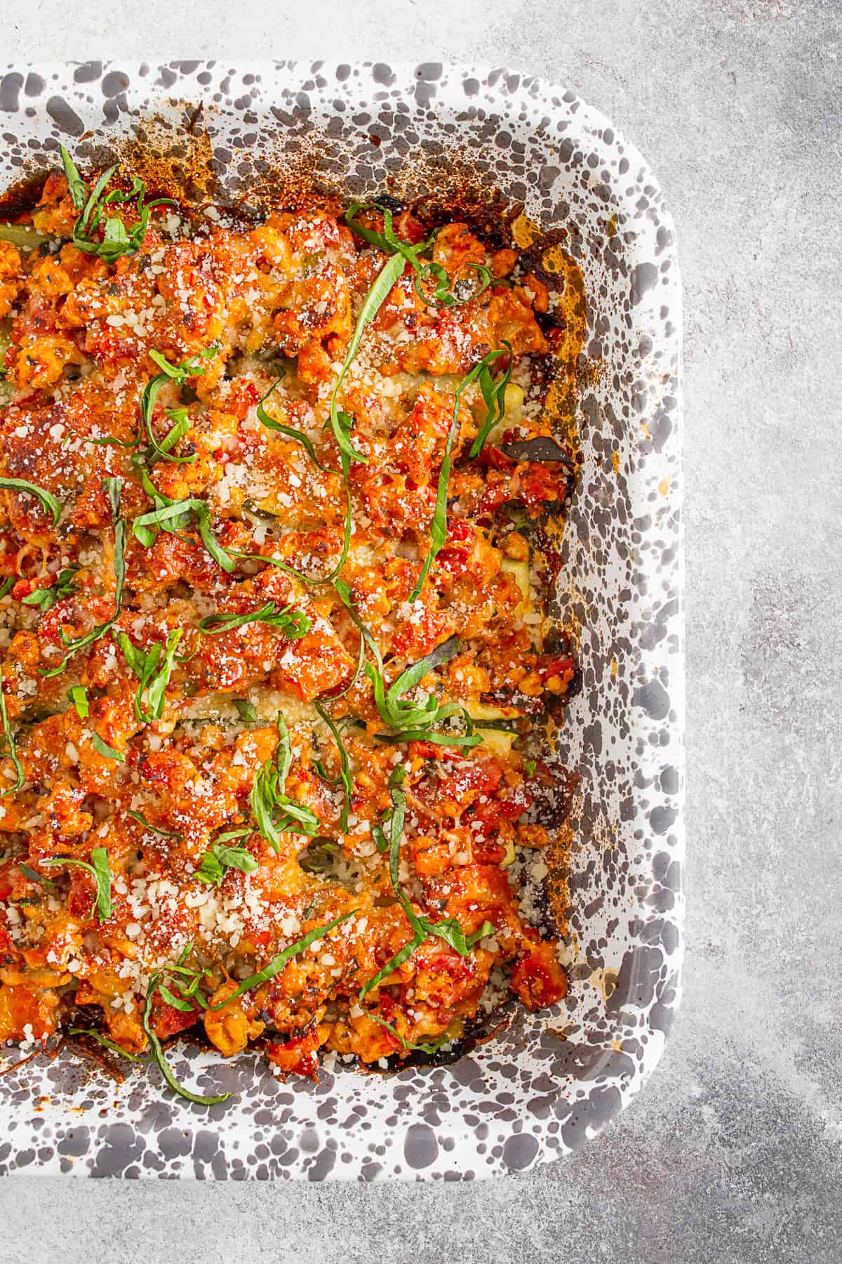 Ground Chicken Parmesan Stuffed Zucchini Boats in a casserole pan.