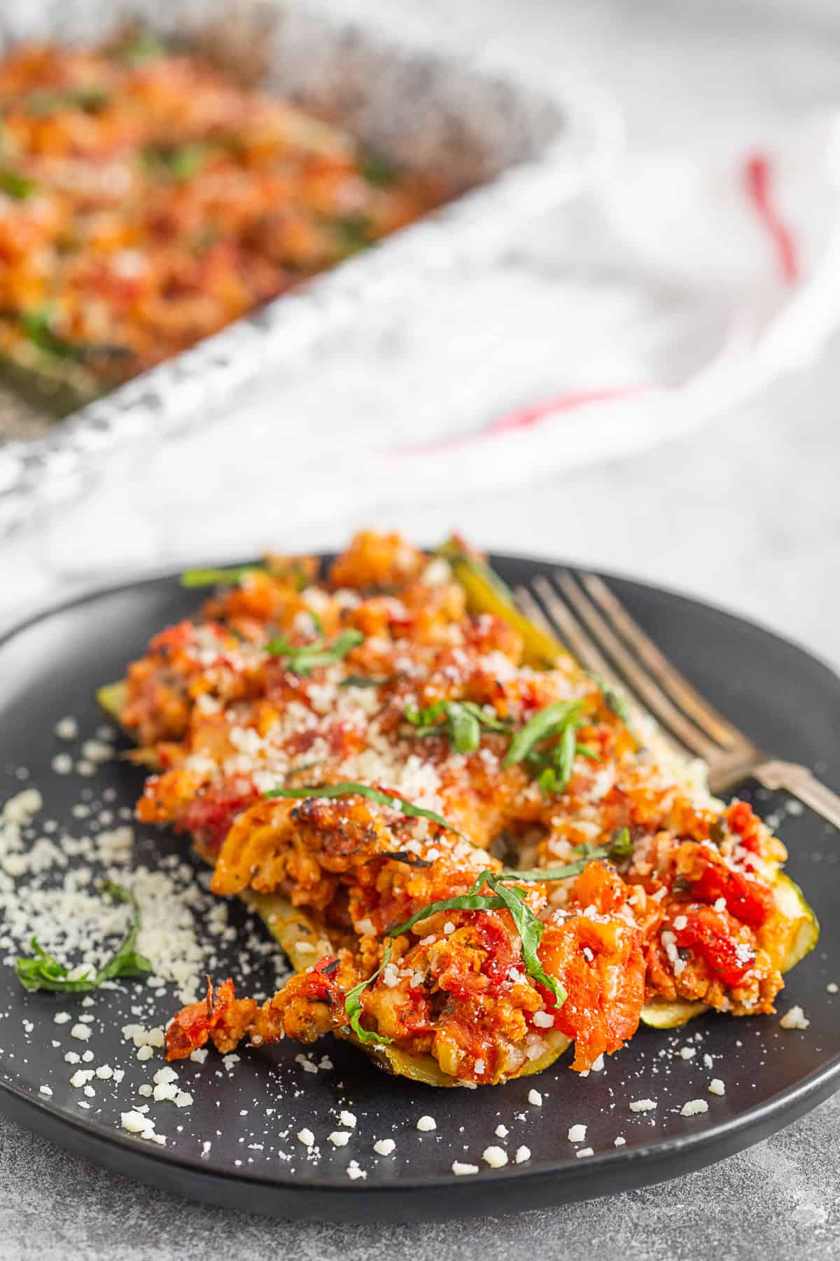 Ground Chicken Parmesan Stuffed Zucchini Boats on a plate.