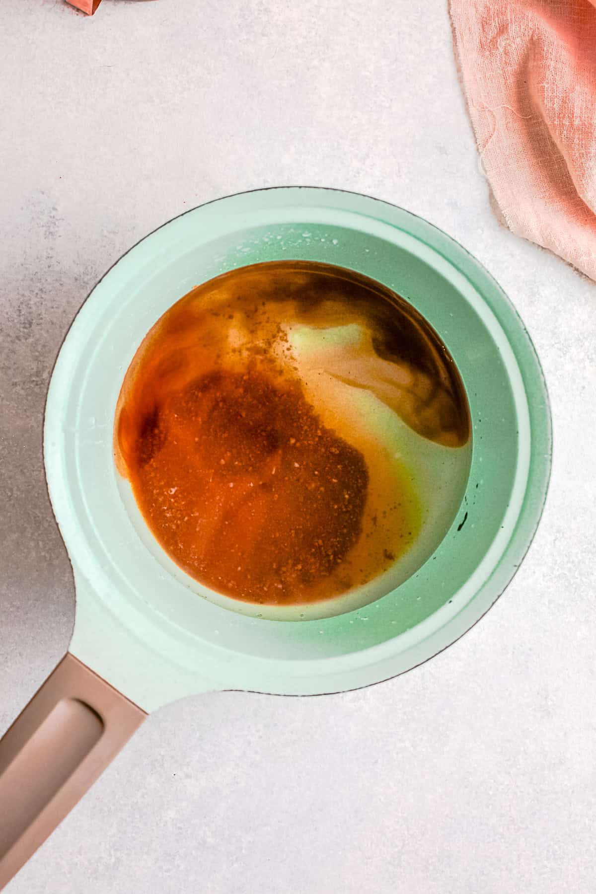 Brown sugar and water in a pot. 