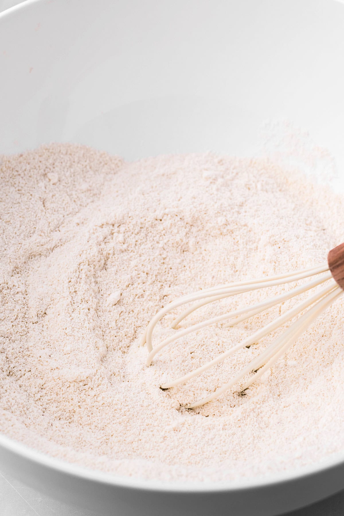 almond flour and powdered sugar whisked together in a bowl. 
