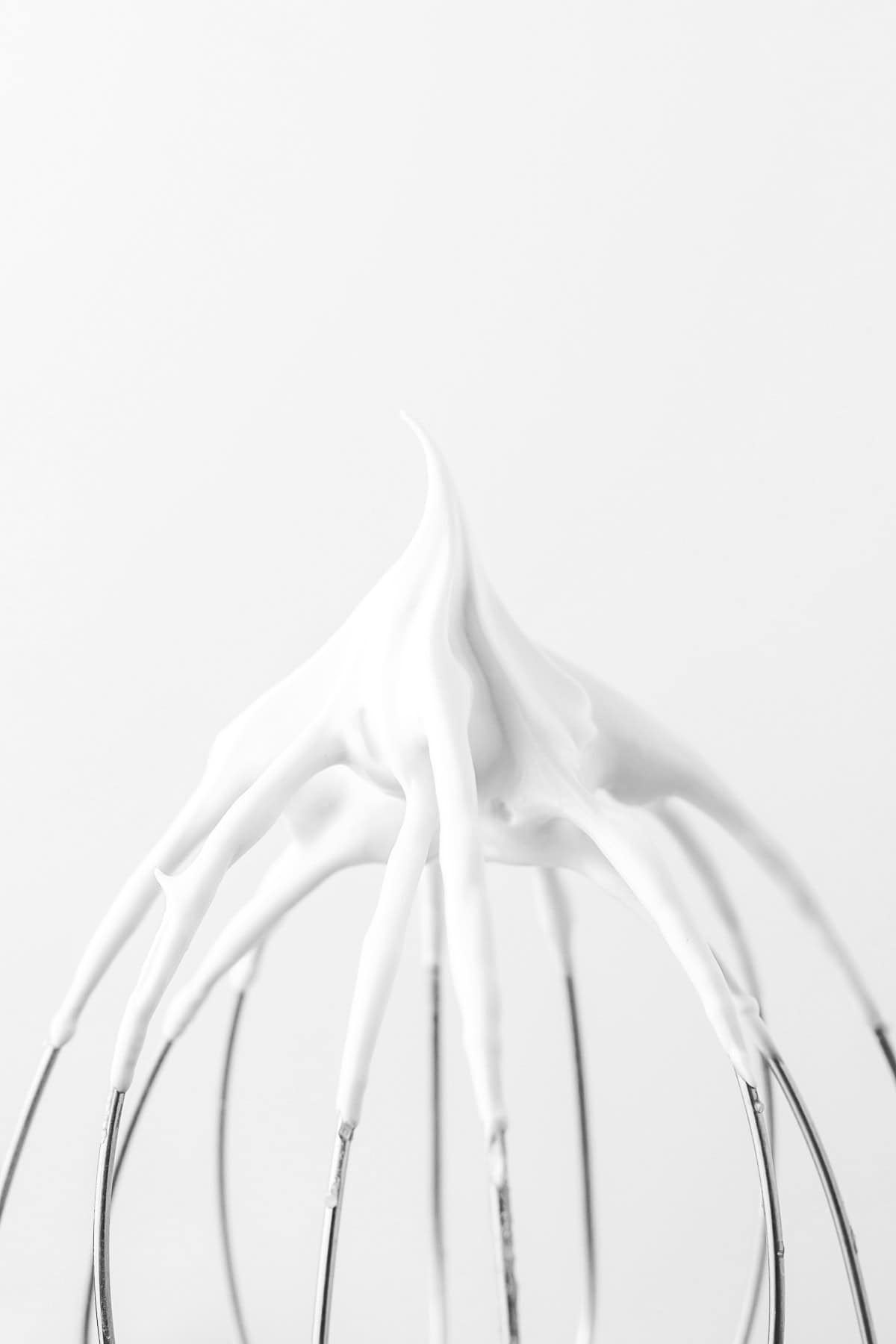 Whipped meringue on a beater. 