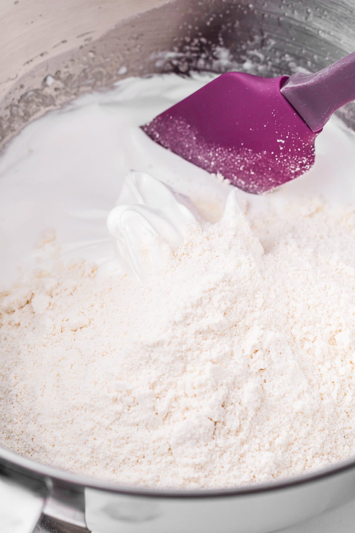 Macaron batter being folded. 