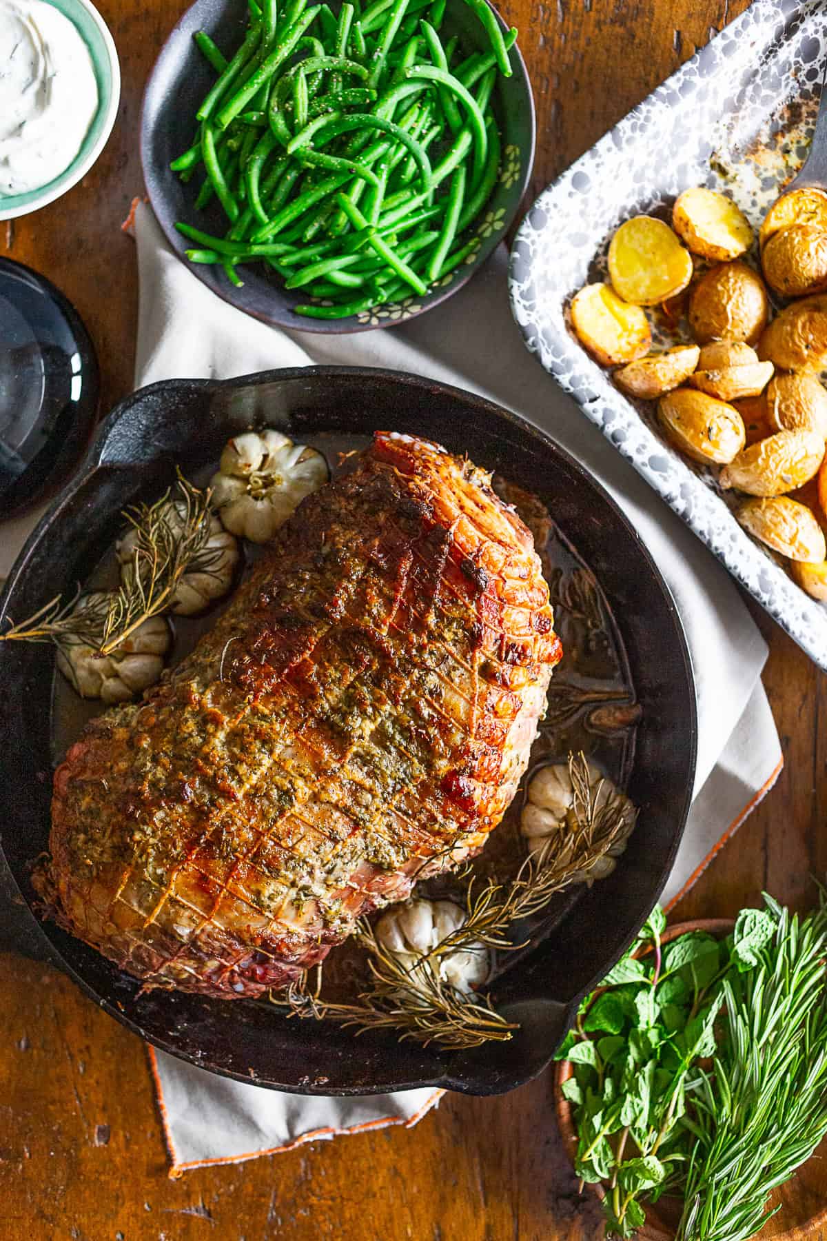 Garlic Rosemary Roast Leg of Lamb served in a cast iron skillet. 