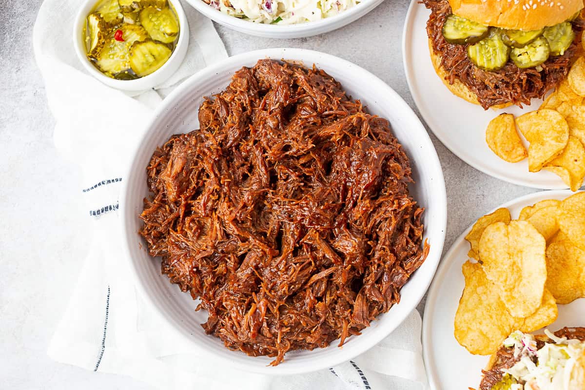 BBQ beef in a large white serving bowl. 