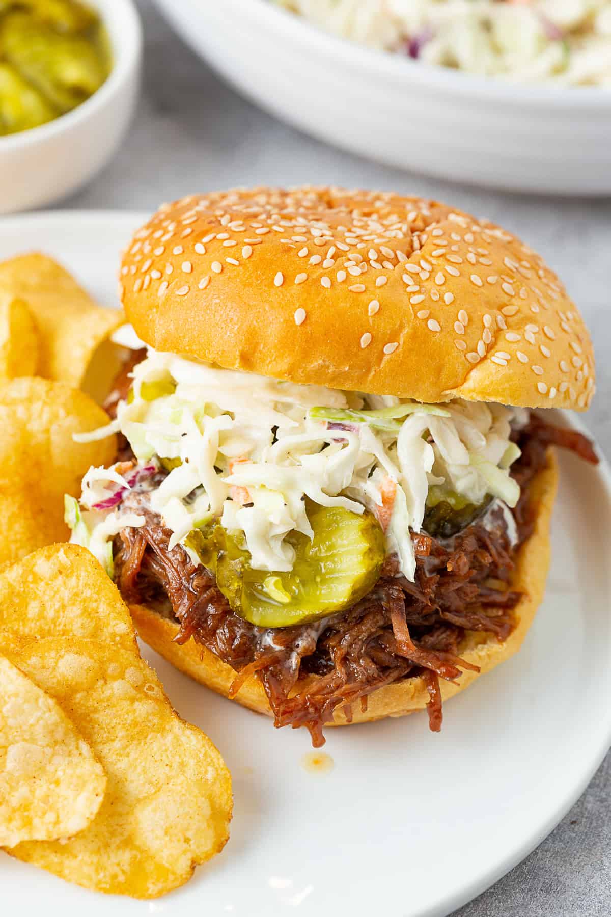 BBQ Shredded Beef (Sandwiches) topped with coleslaw and pickles. 