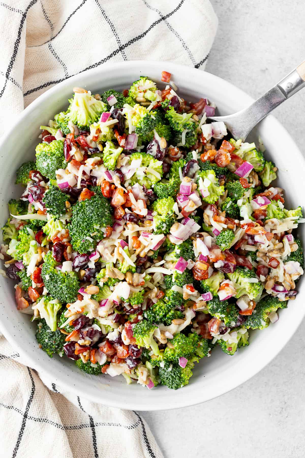 The Best Broccoli Salad in a bowl with a napkin. 