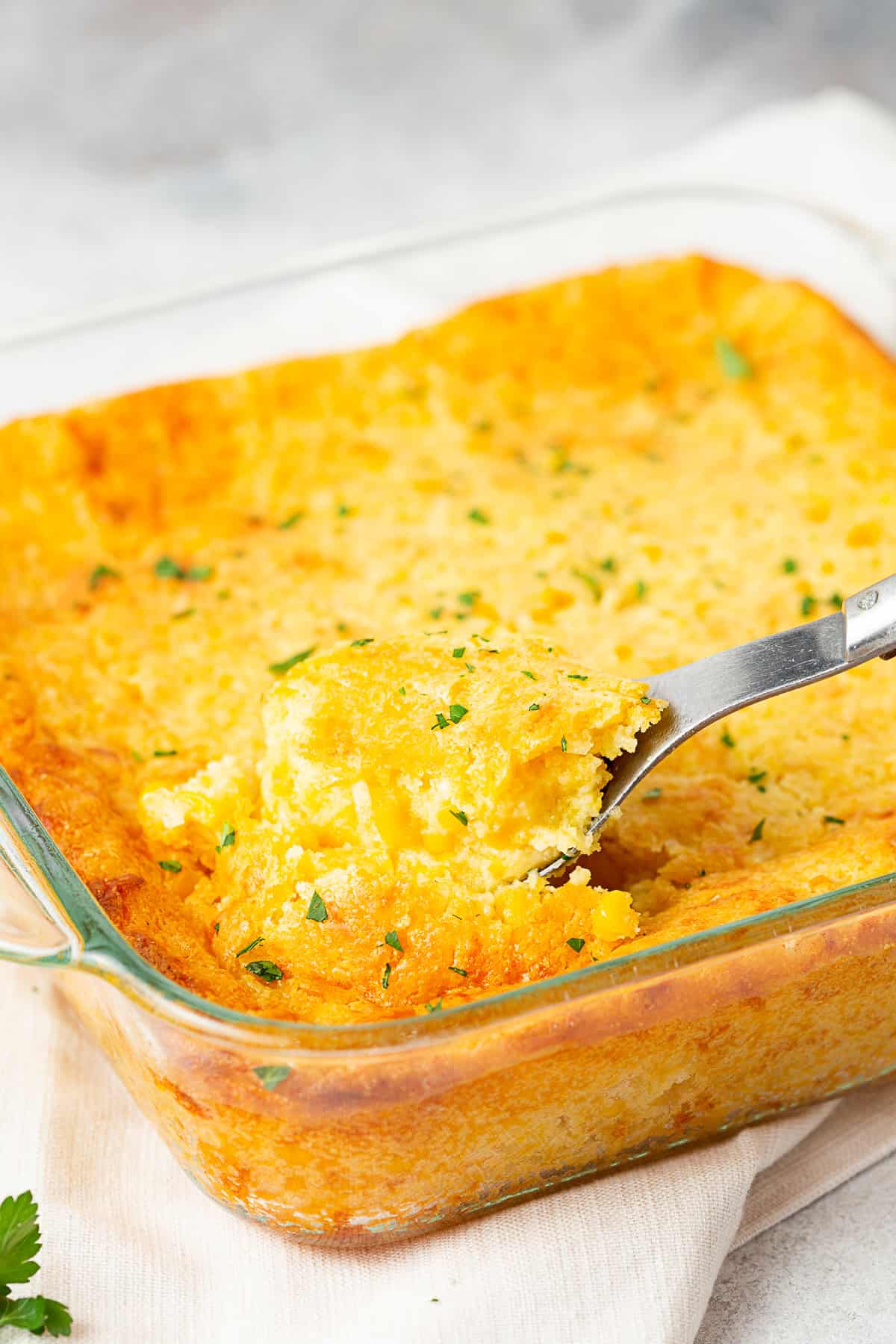 Corn Casserole in a glass baking dish. 