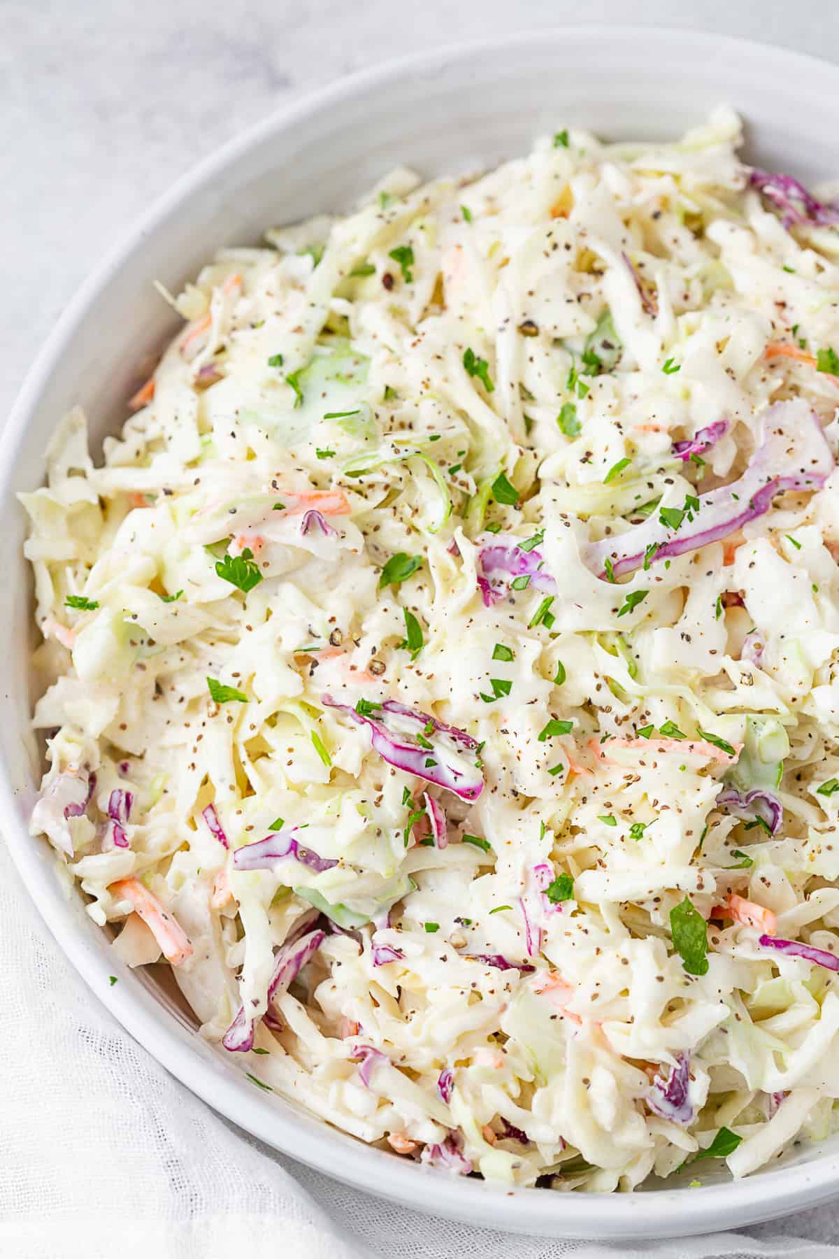 Creamy Coleslaw in a white serving bowl.