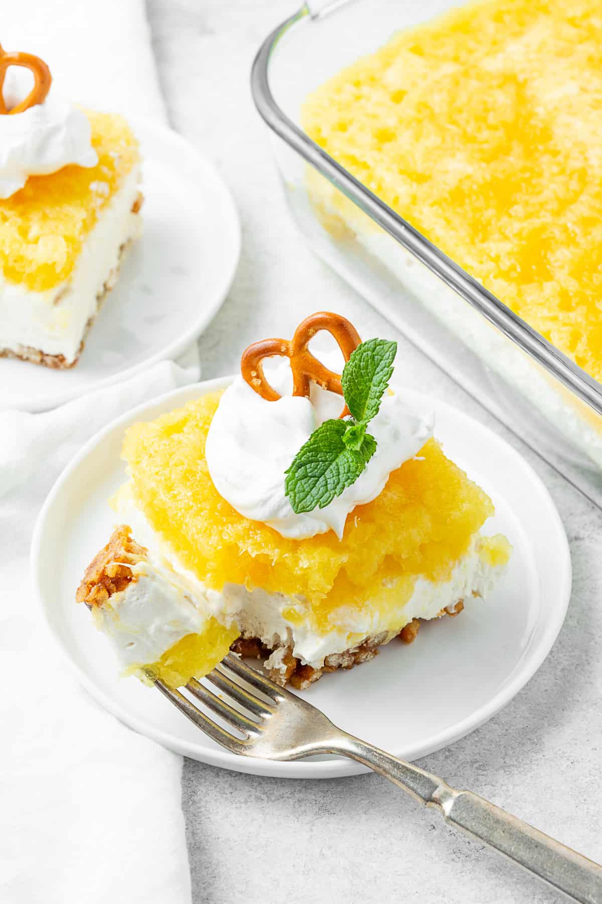 Pineapple Pretzel Salad on a plate with a fork. 