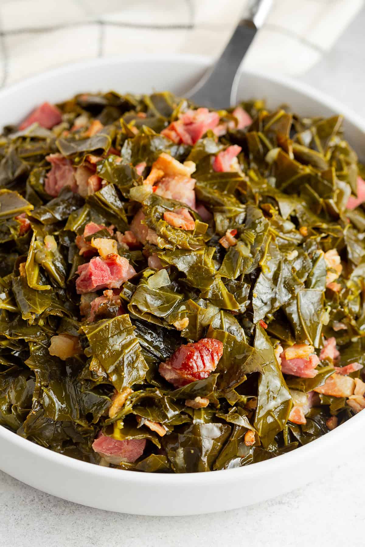 Instant Pot Collard Greens served with pieces of ham.
