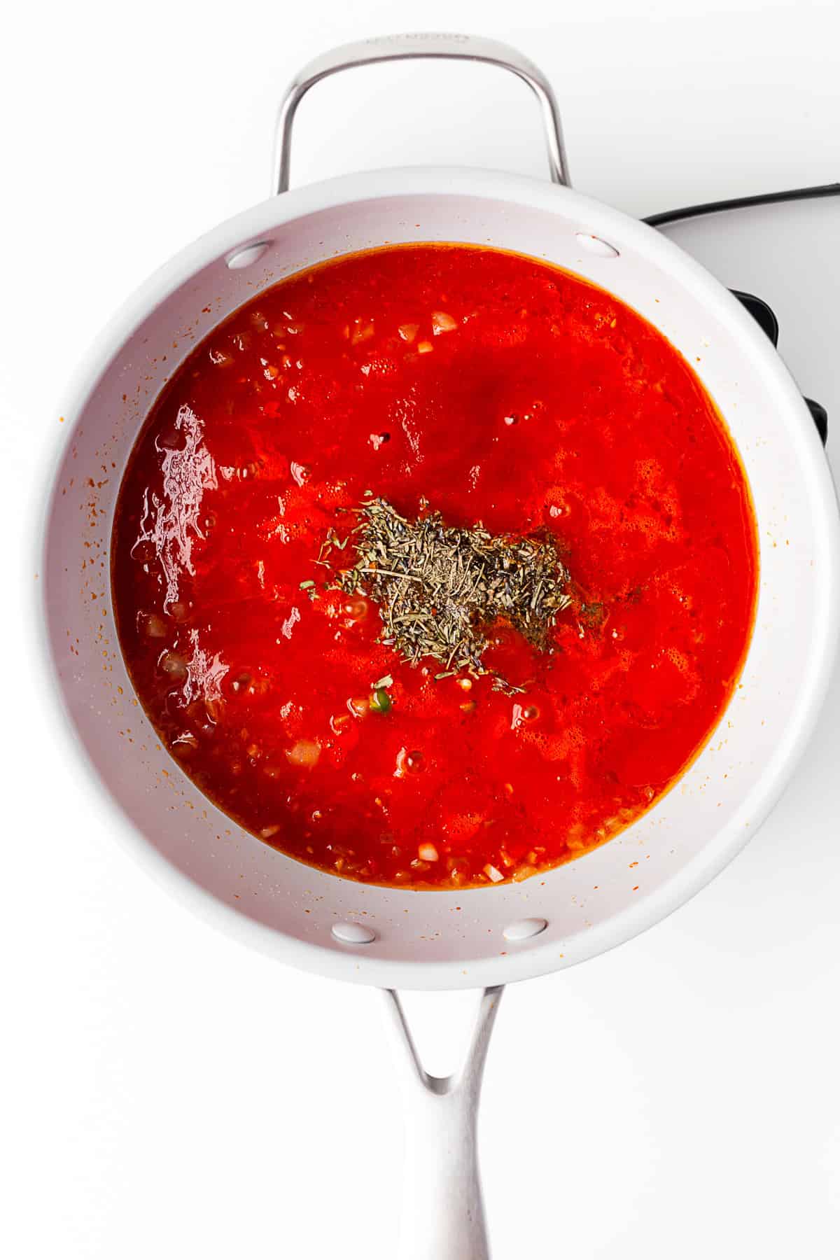 A pan of simmering tomato sauce.