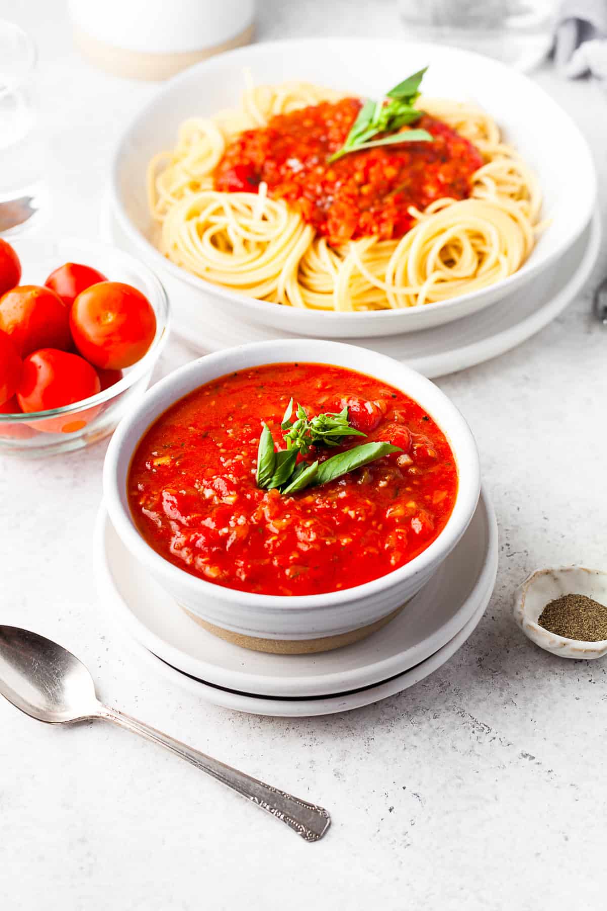 Spicy Tomato Sauce in a bowl with pasta in the background.