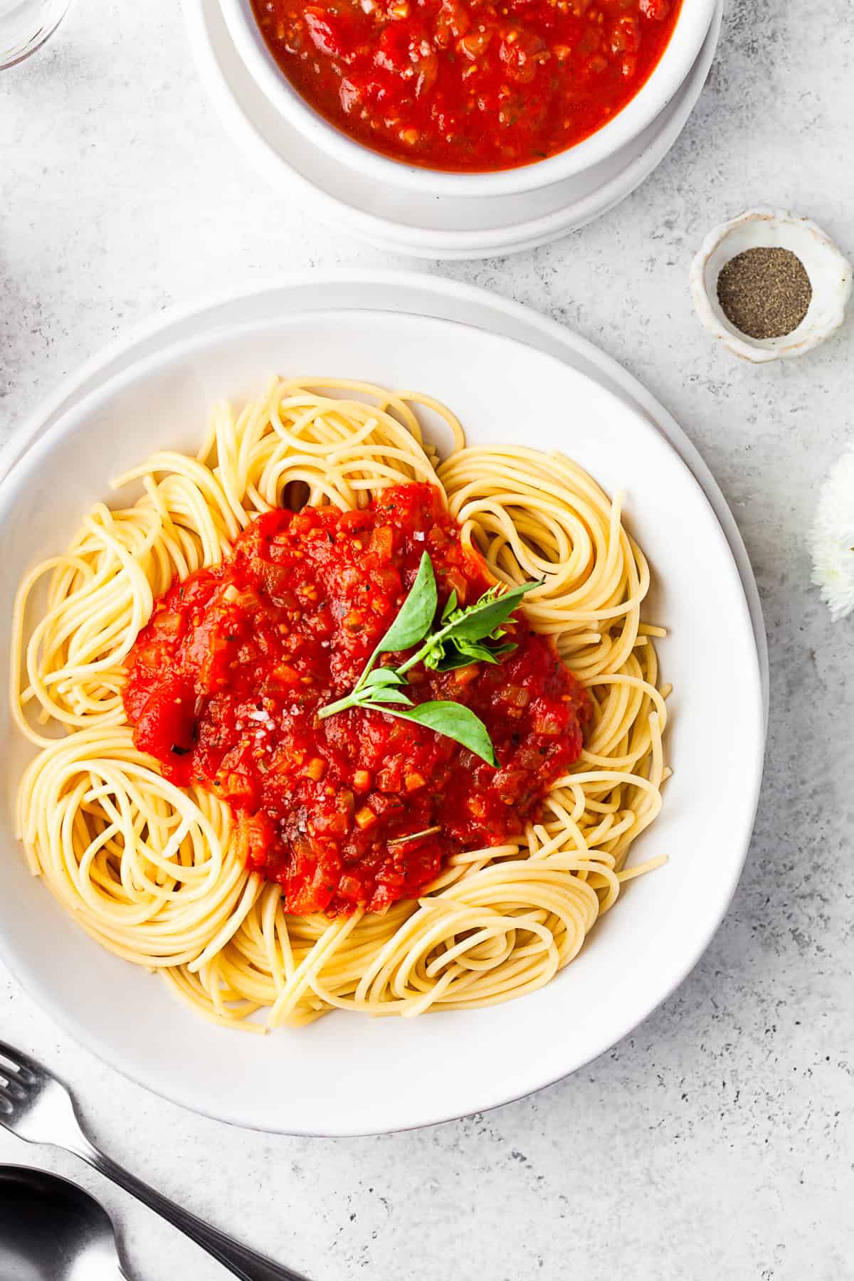 Spicy 30-Minute Tomato Sauce by Nutmeg Nanny Spicy Tomato Sauce over paste with fresh basil.