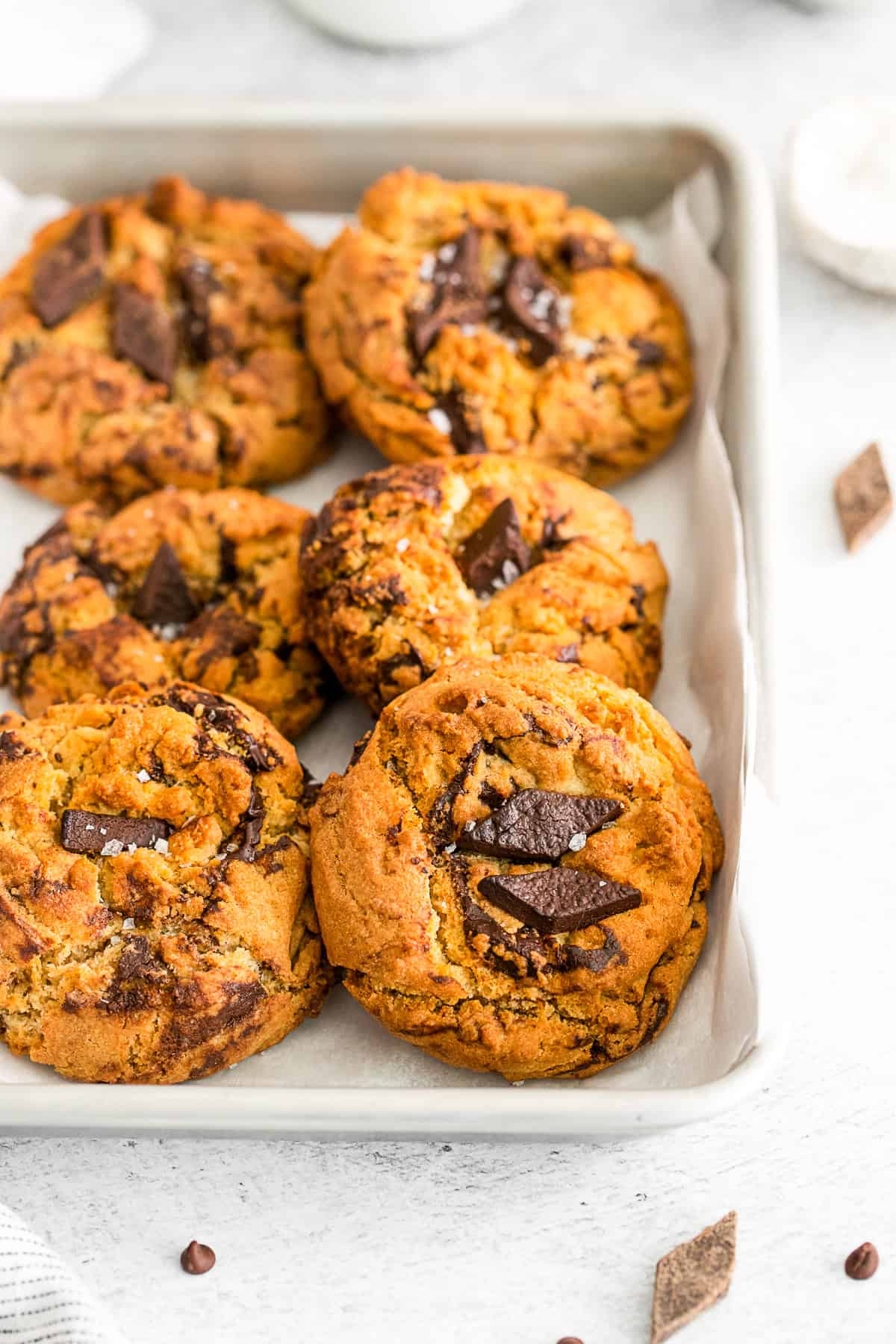 Air Fryer Chocolate Chip Cookies on a parchment lined baking sheet. 