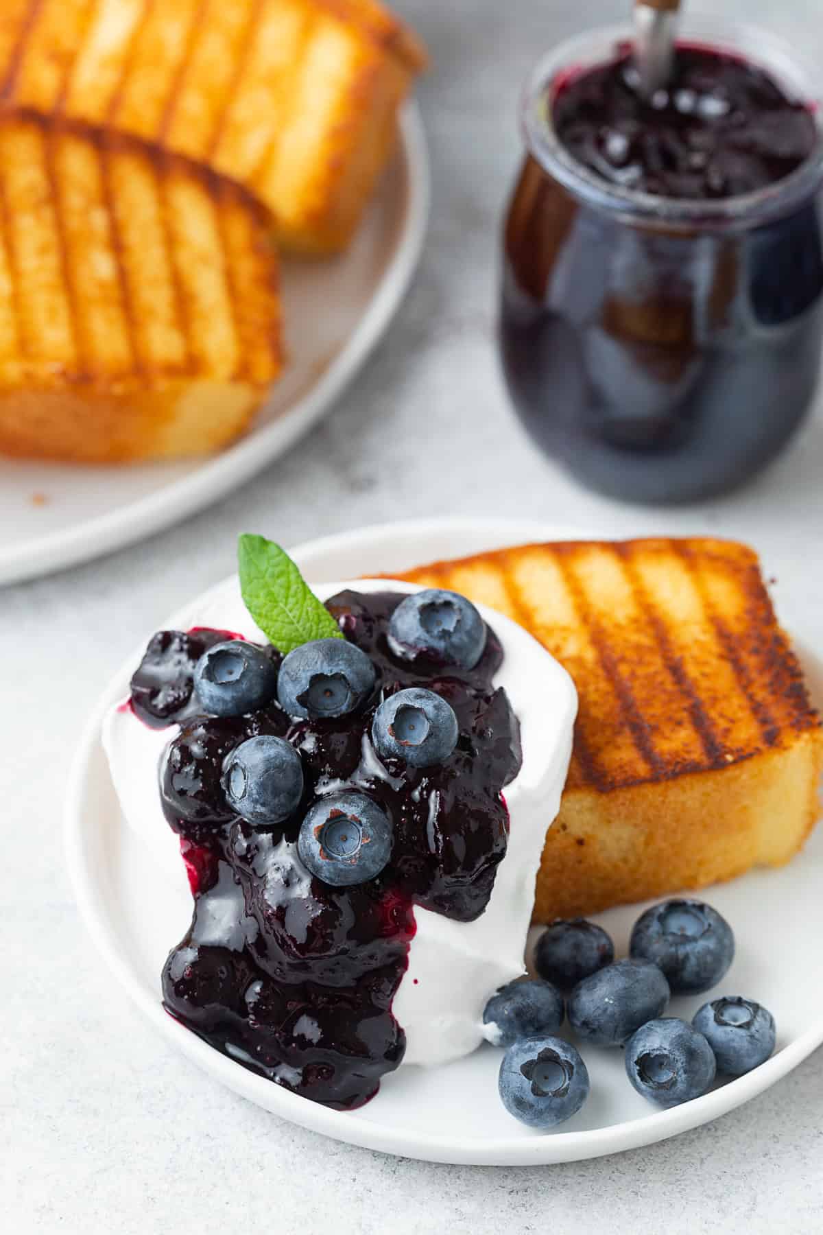 Grilled Pound Cake a la Mode by Nutmeg Nanny Grilled Pound Cake topped with blueberry compote, fresh blueberries and whipped cream.