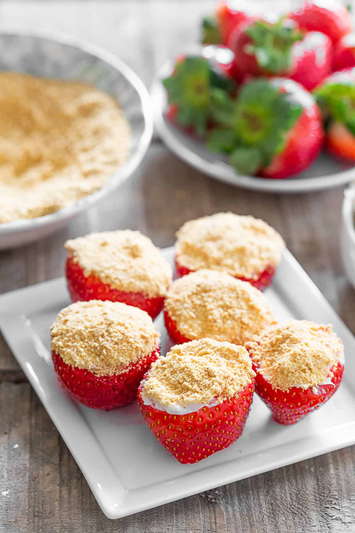 Cheesecake Stuffed Strawberries topped with graham cracker crumbs. 