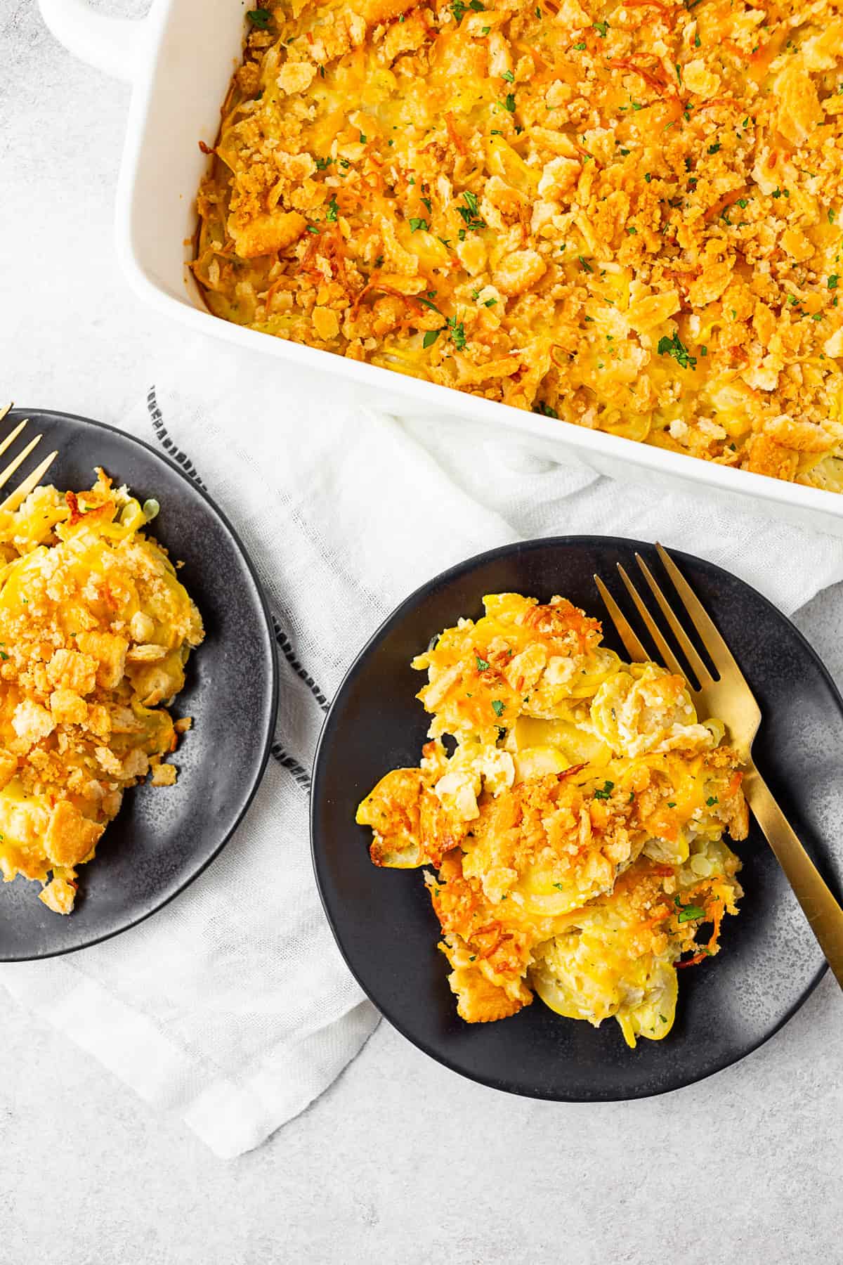 Yellow Squash Casserole spooned onto 2 plates. 