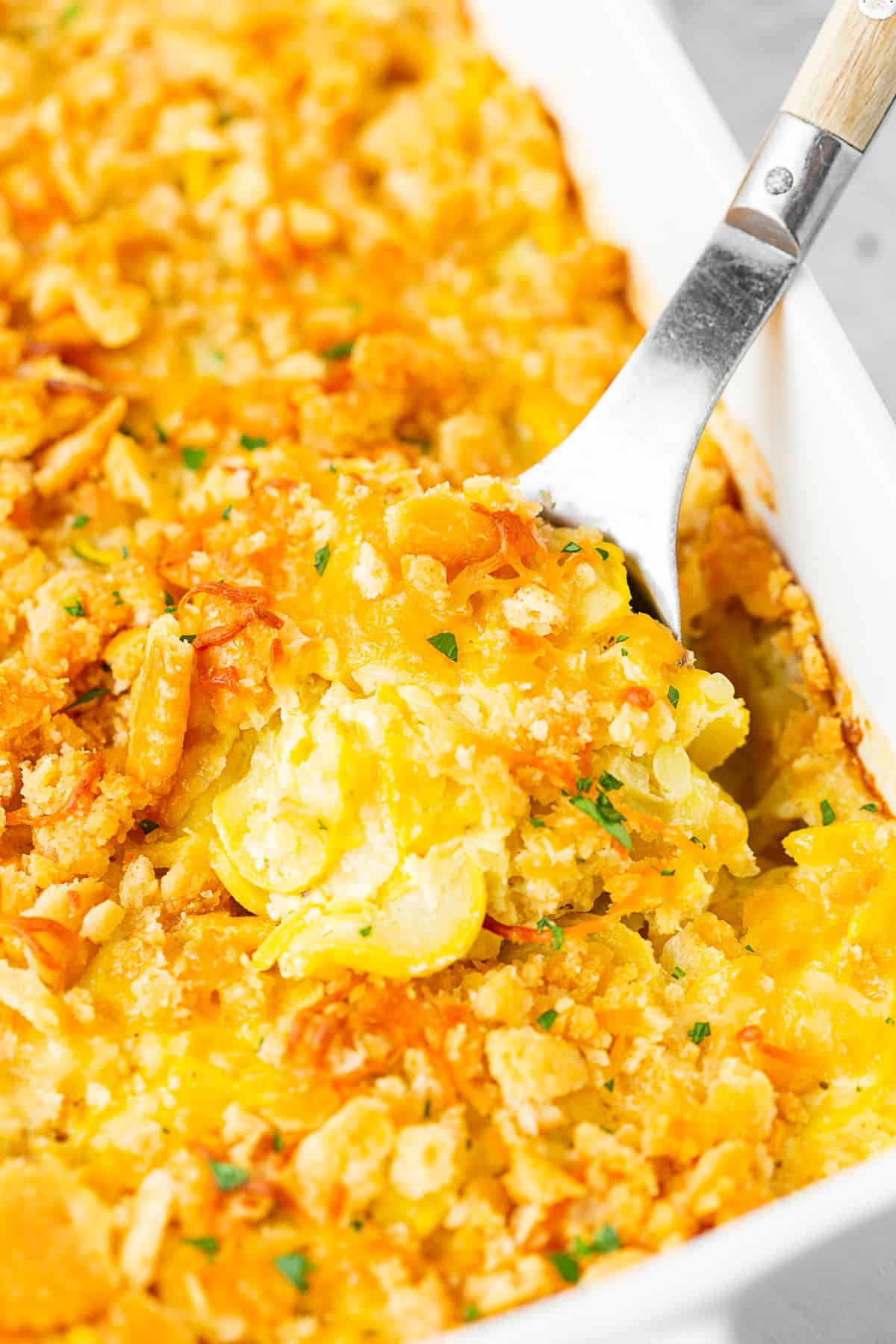 Yellow Squash Casserole in a white baking dish. 