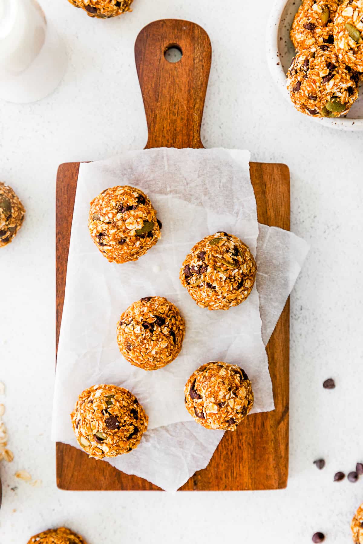 Pumpkin Energy Balls on a wooden cutting board. 