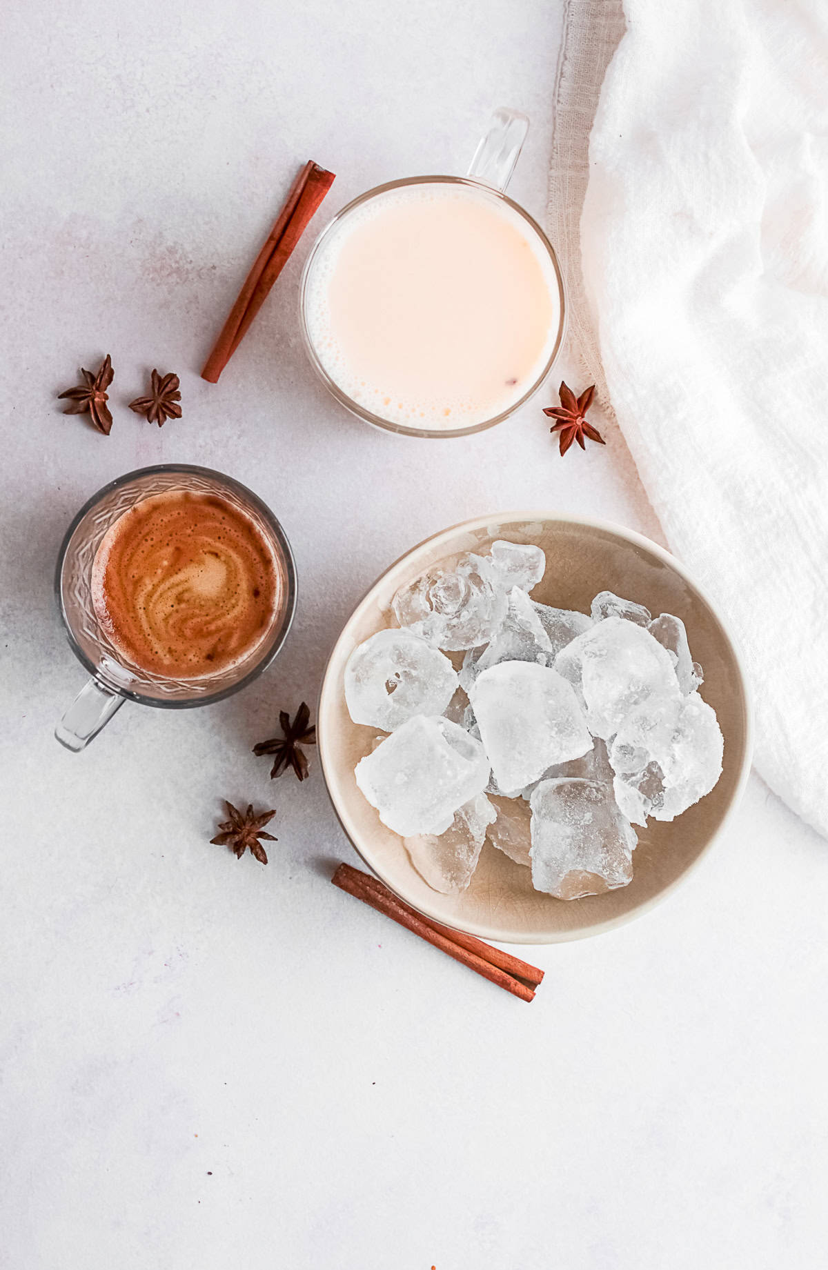 A bowl of ice, espresso and eggnog on a table.