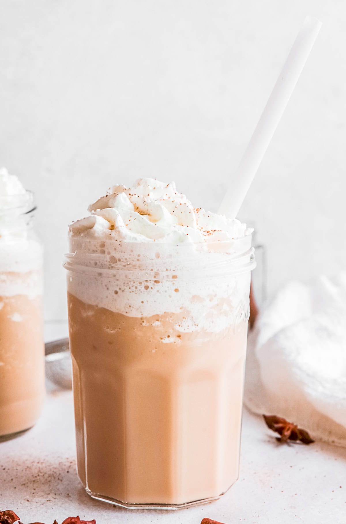 Eggnog Frappuccino in a glass with a straw.