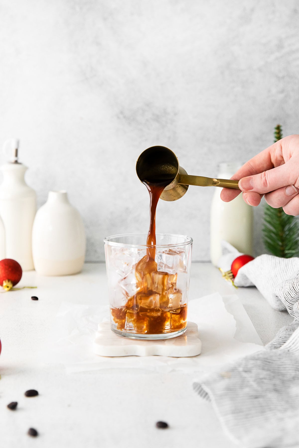 Kahlua being poured into a cocktail glass over ice. 