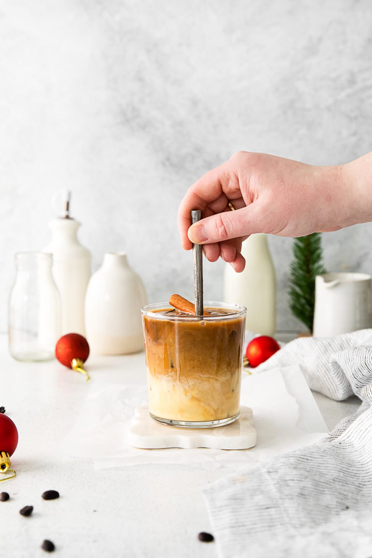 A hand stirring an Eggnog White Russian. 