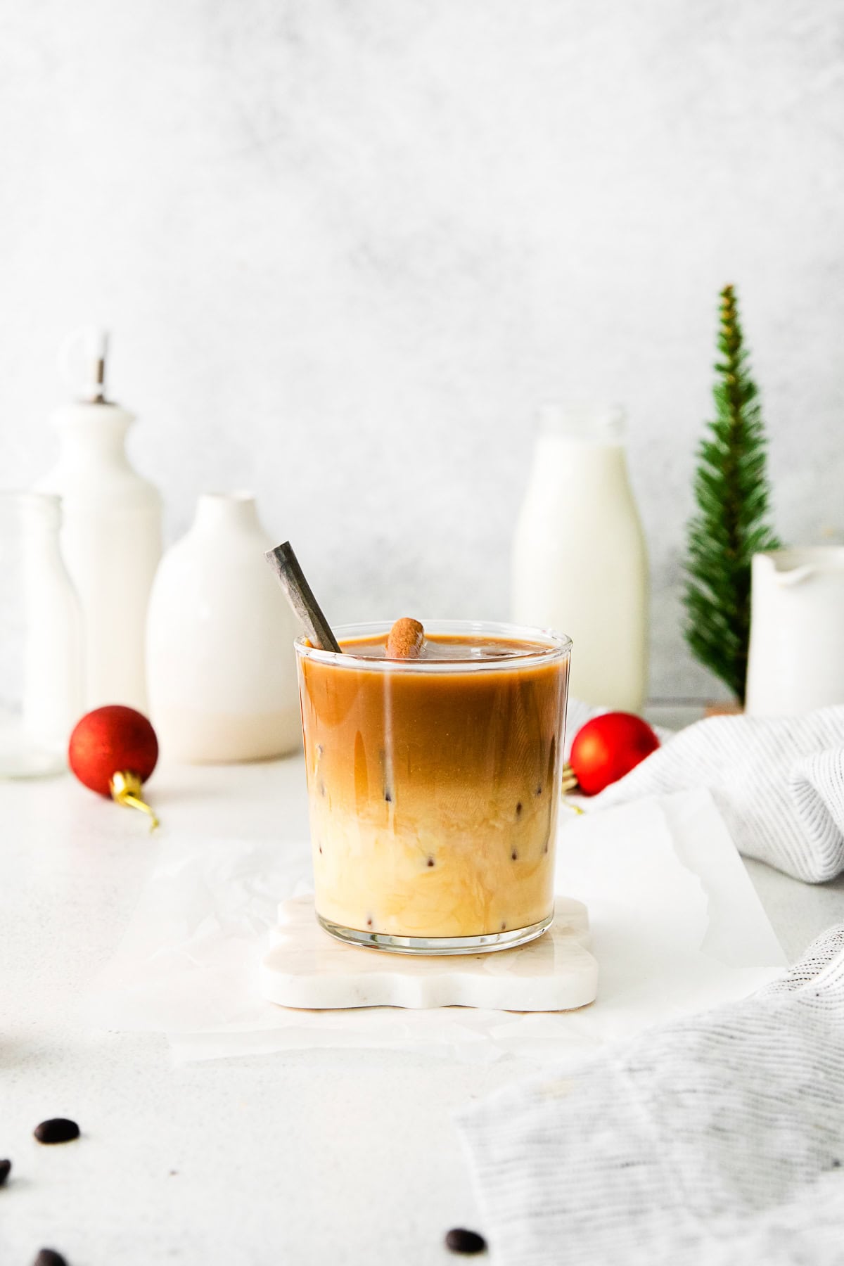 Eggnog White Russian in a glass with a cinnamon stick. 