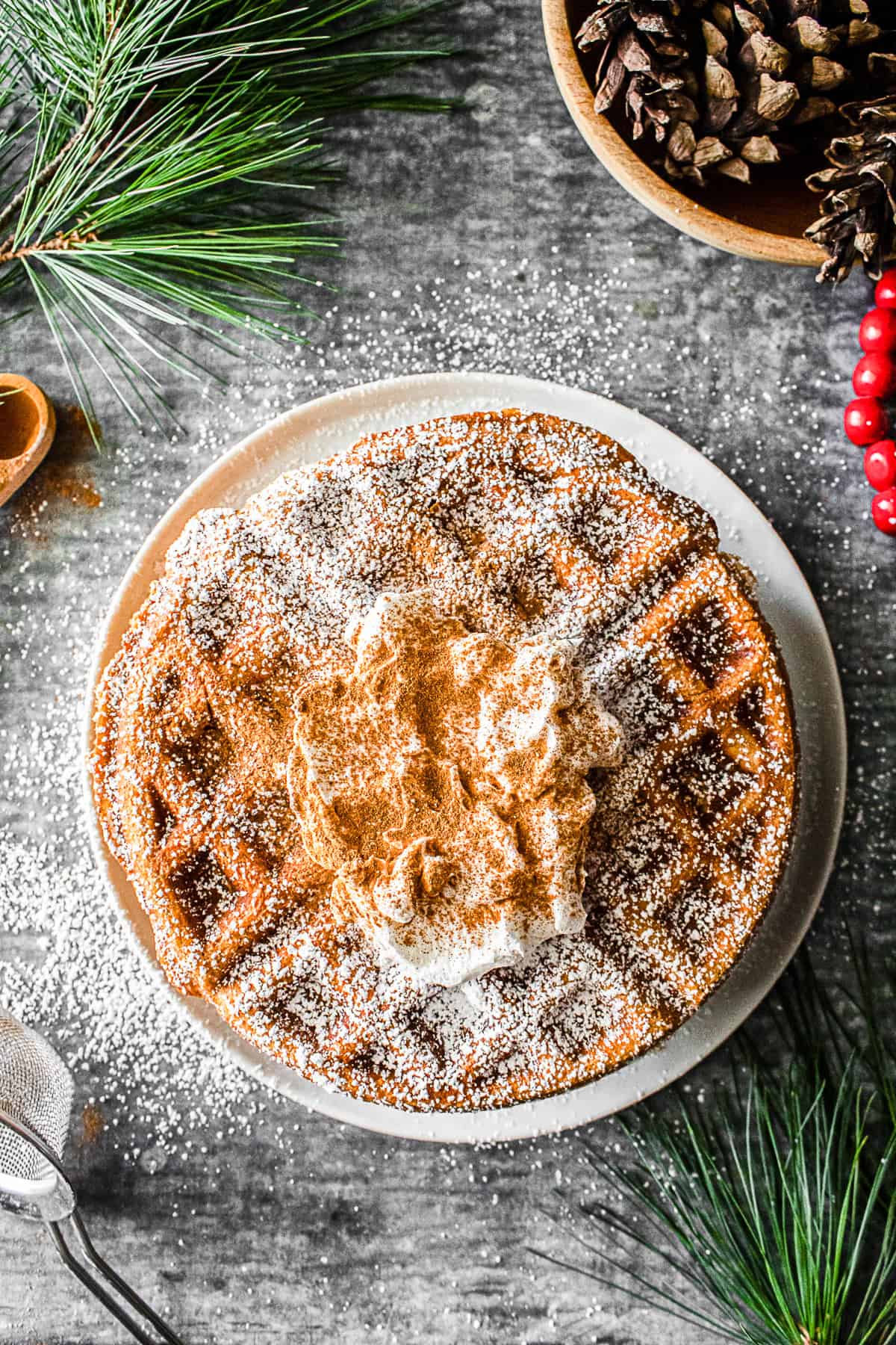 Gingerbread Waffles served with whipped cream, cinnamon, and powdered sugar. 