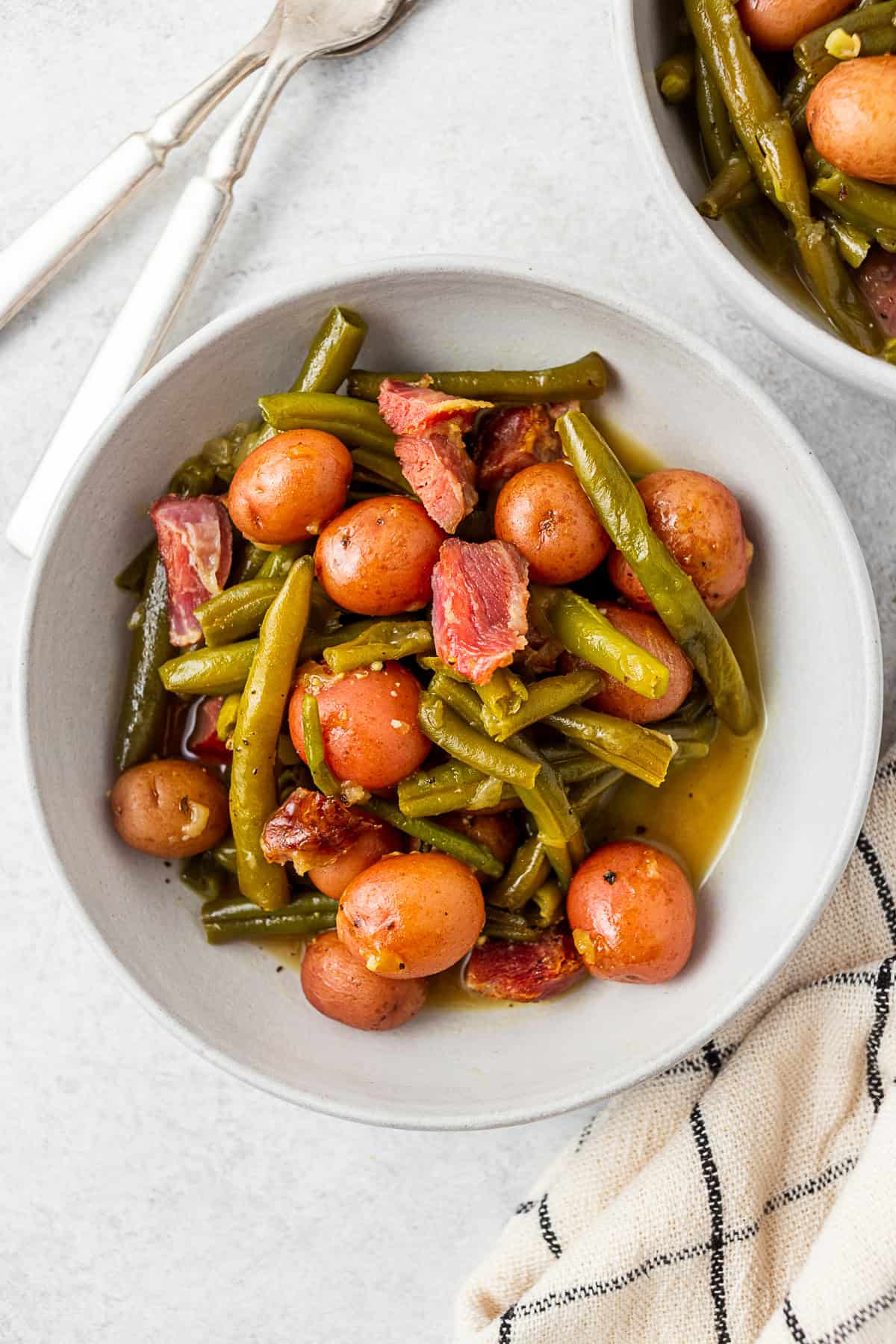 Green beans, ham, and potatoes in a grey bowl.